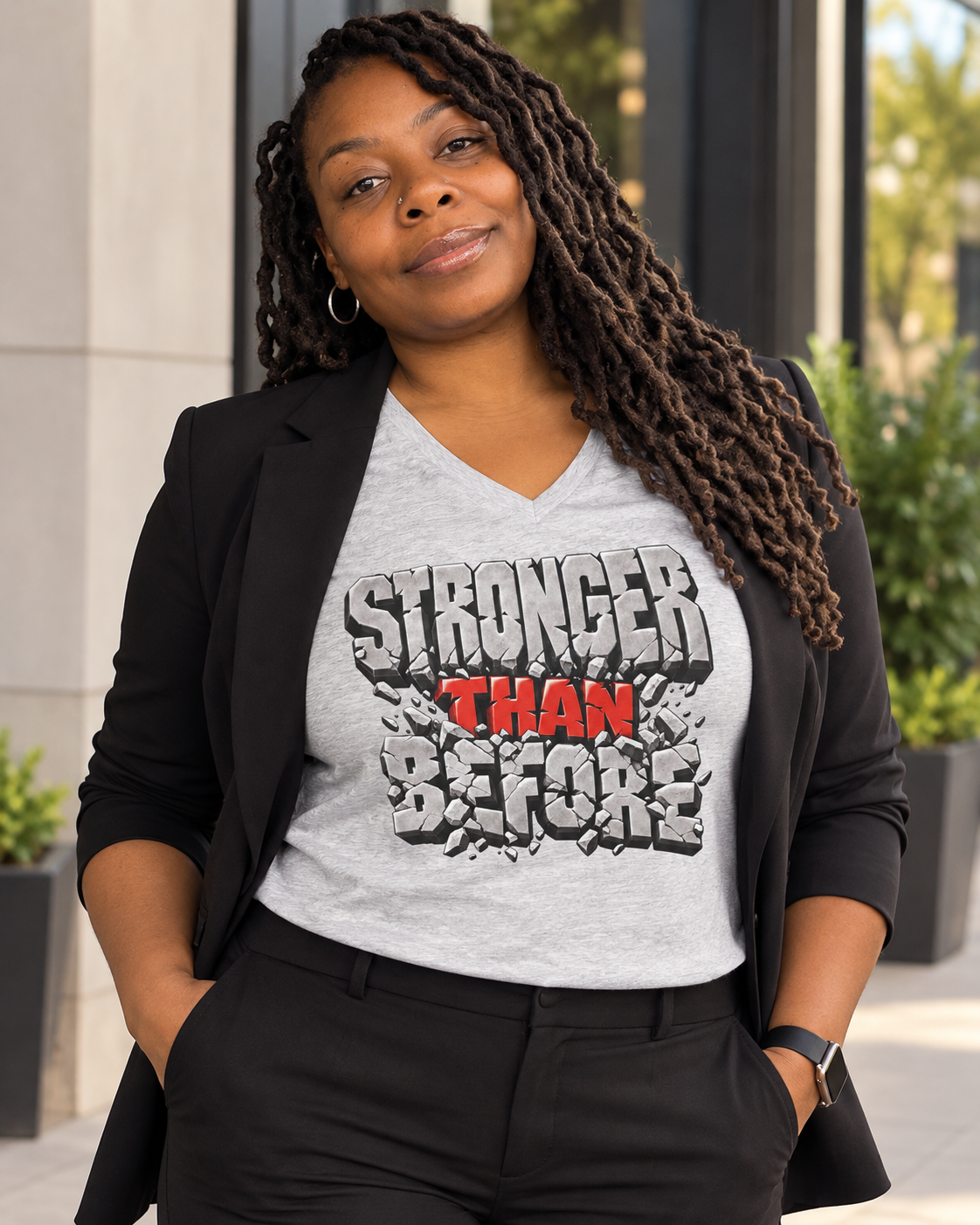 Model wearing Stronger Than Before graphic tee styled with a black blazer
